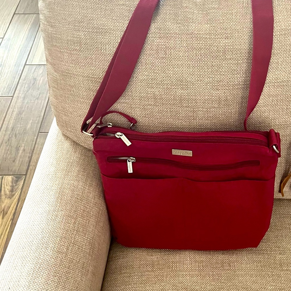 Baggalini purse, pockets and zipper in front and 2 more zippers